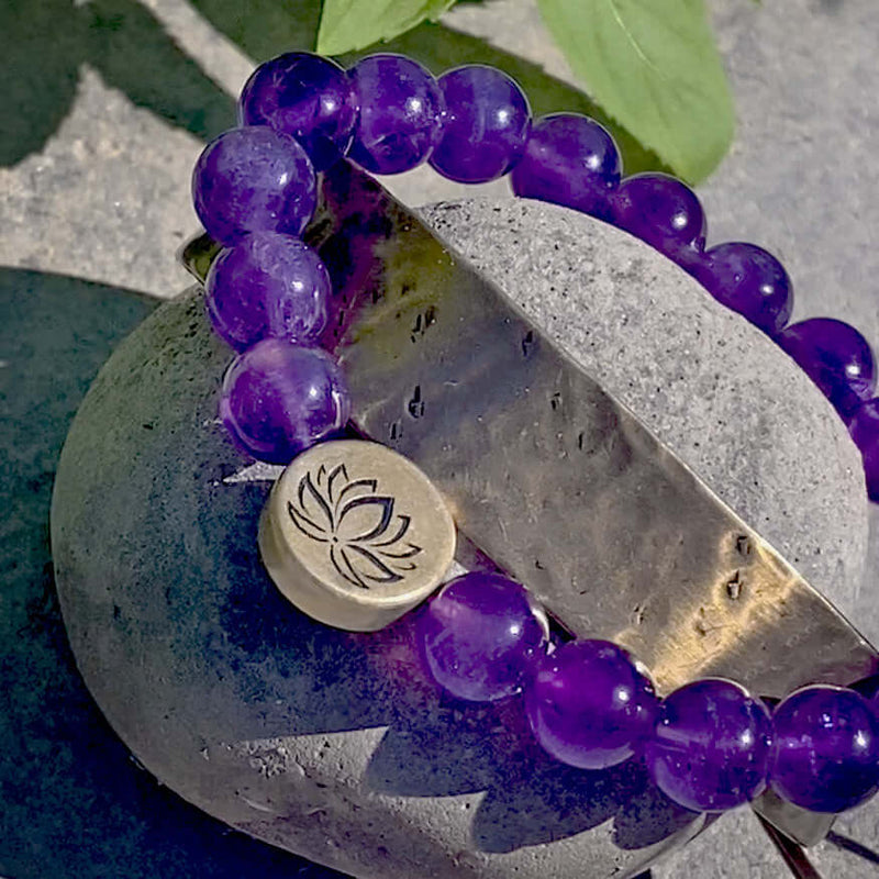 Lotus Stretch Bracelet - Gemstone Beaded Stretchy Bracelet on a stone background featuring amethyst beads.