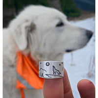 Midnight Wolf Adjustable Ring with wolf design, mountains, and stars, showcased against a snowy background.