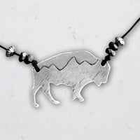 Mountains on Buffalo Necklace featuring a silver bison charm with mountain peaks and decorative beads.