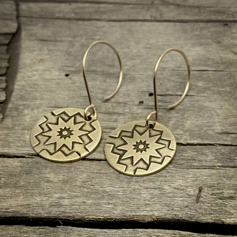 Northstar Earrings feature etched brass design symbolizing inspiration, hope, and guidance on safe earwires.