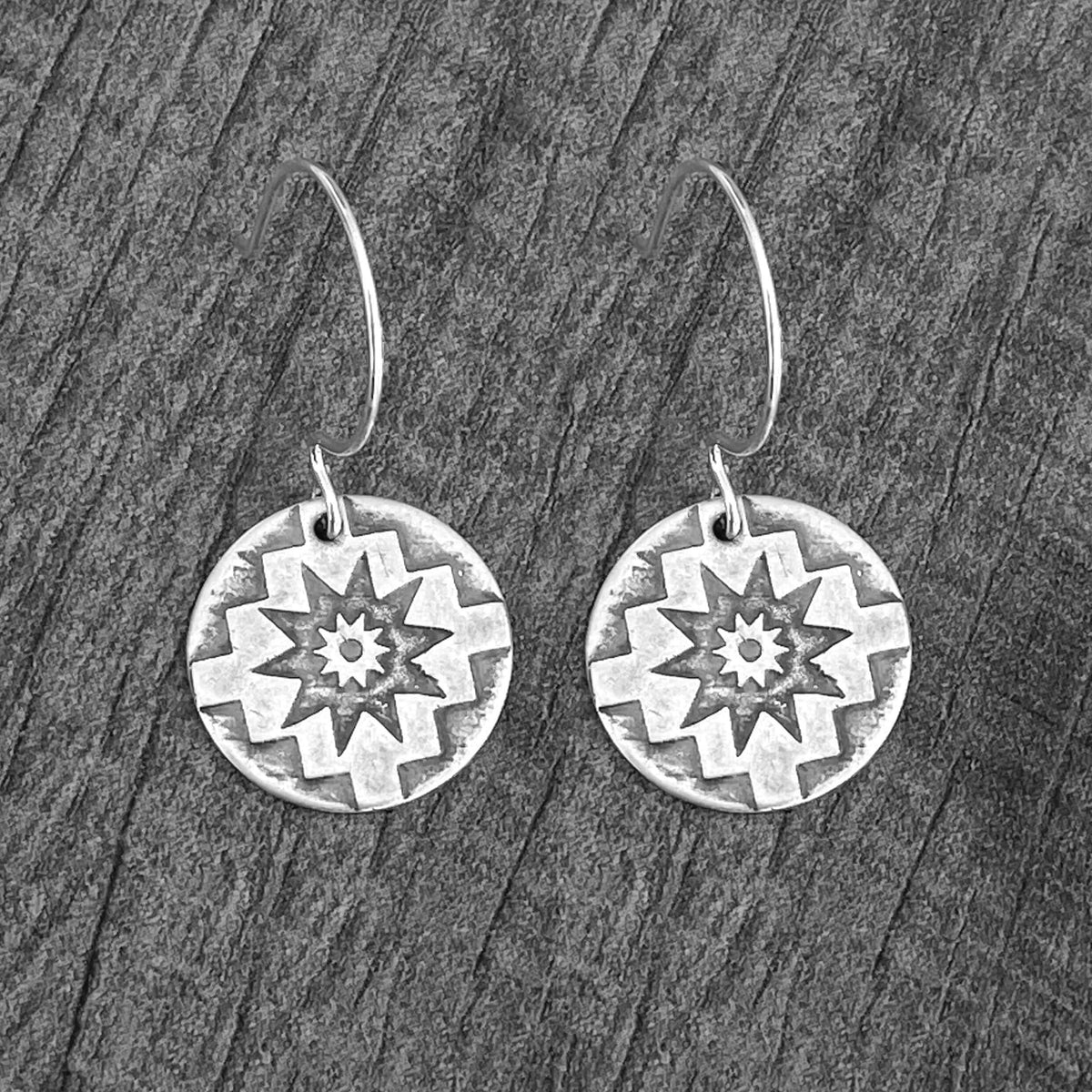 Northstar Earrings featuring etched star design on rounded sterling silver earwires, symbolizing guidance and inspiration.