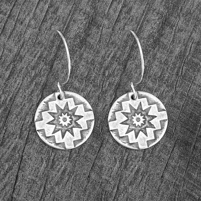 Northstar Earrings featuring etched star design on rounded sterling silver earwires, symbolizing guidance and inspiration.