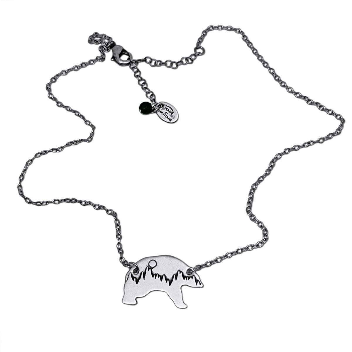 Poya Bear Necklace featuring a bear silhouette and tree line on an adjustable silver cable chain.