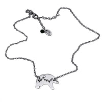 Poya Bear Necklace featuring a bear silhouette and tree line on an adjustable silver cable chain.