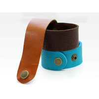 Rising Wolf Leather Cuff Bracelet in espresso and turquoise colors, featuring adjustable fit and antique brass button details.