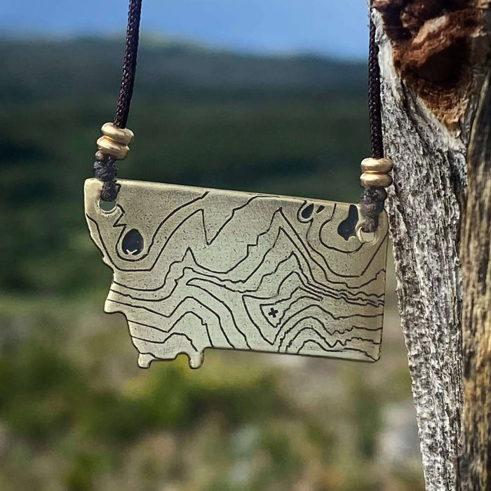 Rising Wolf MT Necklace - Topo Montana featuring a topographic design of Montana mountains on a pendant.