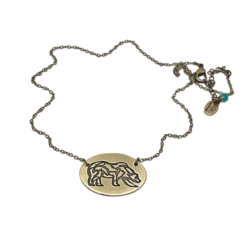 Rocky Bear Necklace featuring an elegant grizzly bear pendant on a delicate chain.