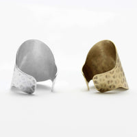 Rubble Adjustable Ring displayed in silver and gold options, showcasing its hand hammered design and versatility.