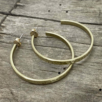 Simple Hoop Earrings in hammered brass with stainless steel posts and 14k gold ear nuts, perfect for everyday wear.