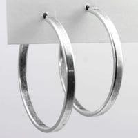 Simple Hoop Earrings displayed on a card, showcasing smooth silver finish and 1.5 inch diameter.