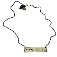 Simple Teton Mountain Necklace featuring a brass pendant with Teton mountain outline and adjustable chain.