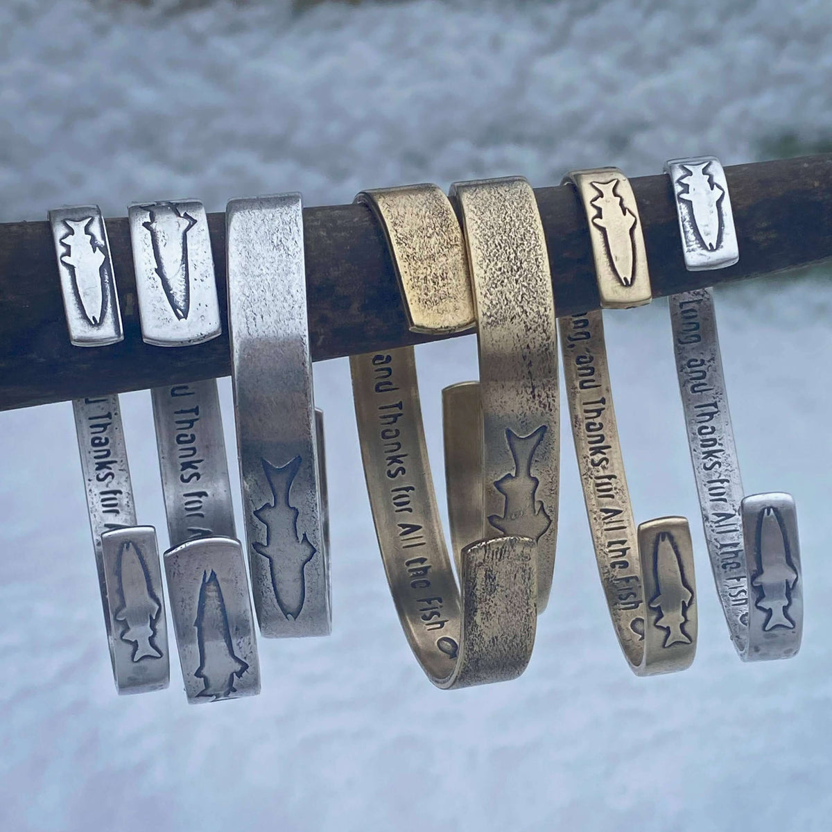 Skinny Fish Cuff Bracelet collection featuring unique brass and silver designs with etched fish details.