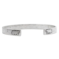 Skinny Bear Cuff Bracelet featuring etched bear designs, made with raw brass, symbolizes strength and courage.