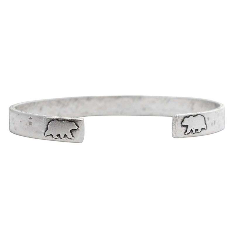 Skinny Bear Cuff Bracelet featuring etched bear designs, made with raw brass, symbolizes strength and courage.