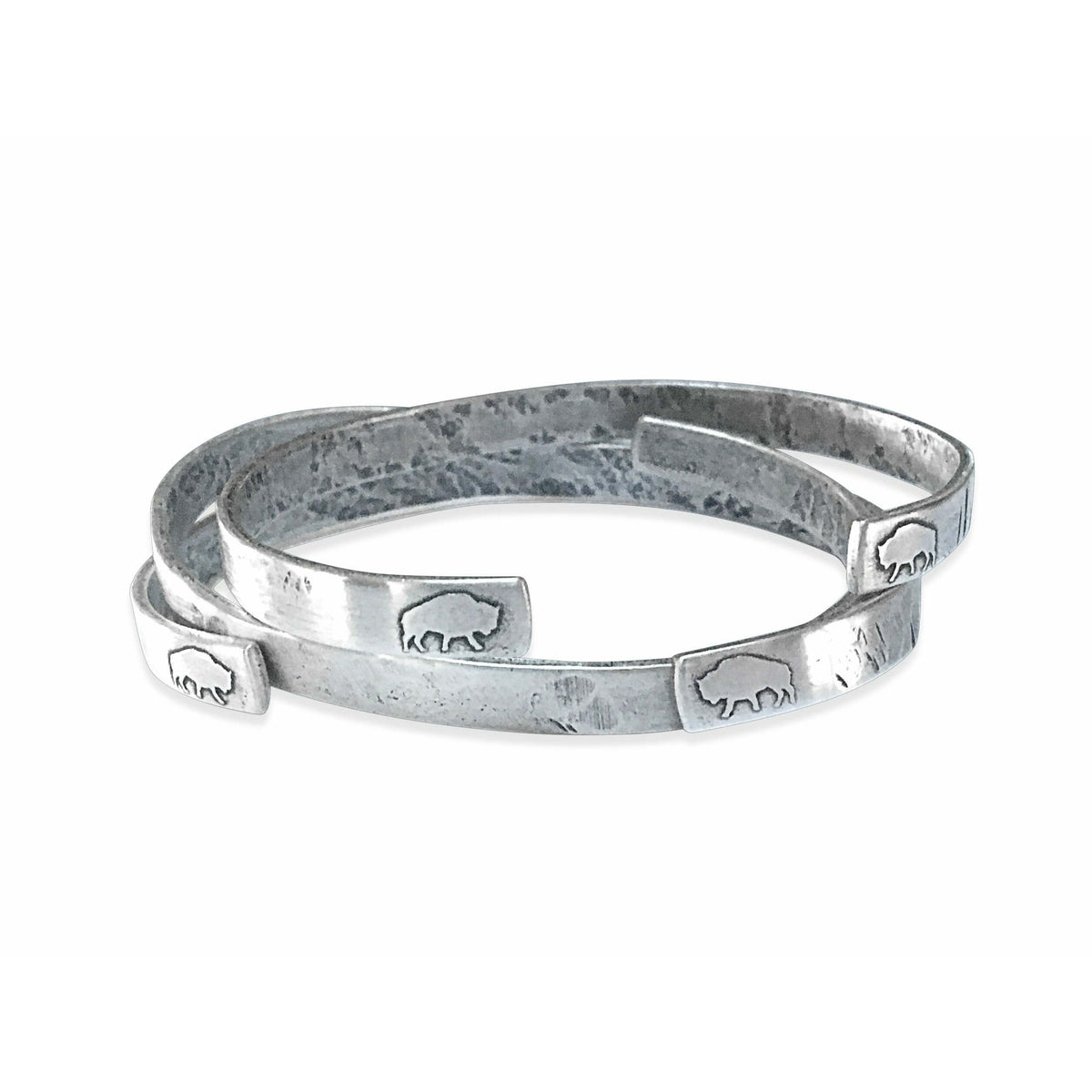 Skinny Fish Cuff Bracelet featuring a raw brass design with etched fish ends and a unique textured finish.