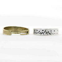 Skinny High Alpine Adjustable Ring design featuring mountains and stars, showcasing raw brass and silver finishes.