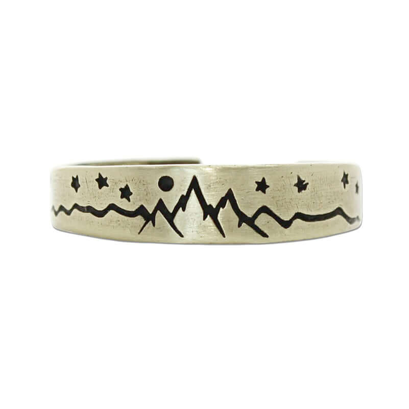Skinny High Alpine Adjustable Ring with etched mountain and star design in raw brass finish.