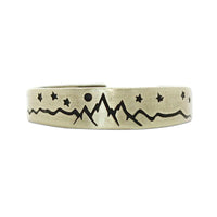 Skinny High Alpine Adjustable Ring with etched mountain and star design in raw brass finish.