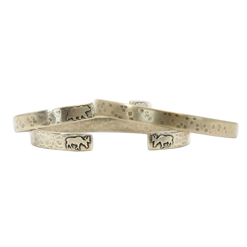Skinny Moose Cuff Bracelet showcasing a unique design with etched moose motifs on raw brass cuffs.