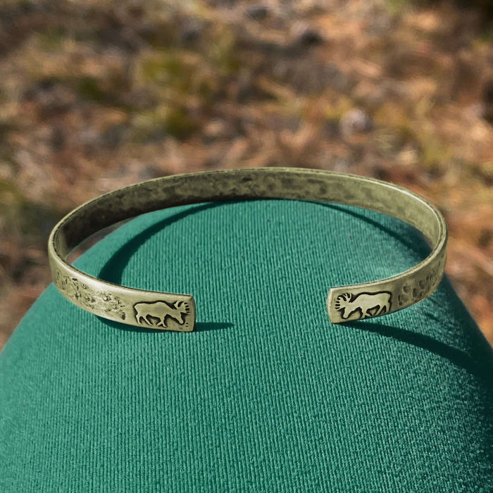 Skinny Moose Cuff Bracelet showcasing moose designs on raw brass with unique acid-free etching.