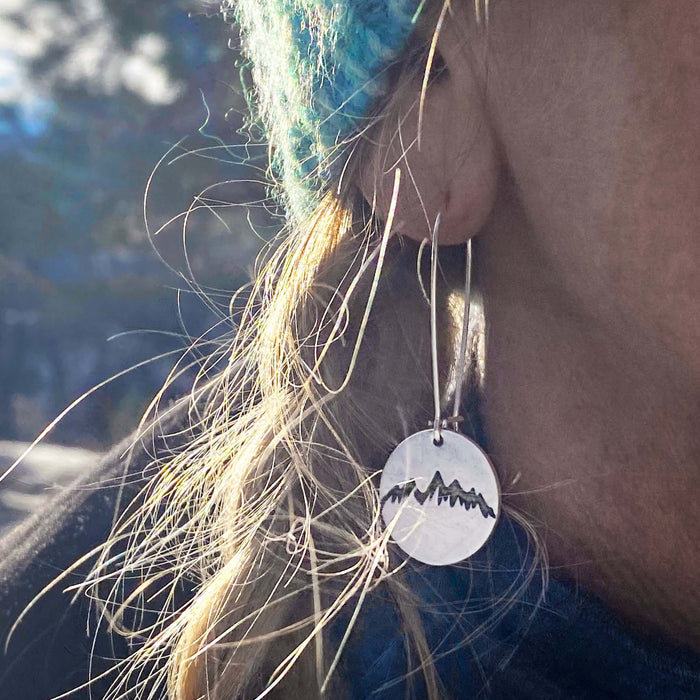 Snowcap Mountain Earrings worn by a person, showcasing elegant snowcapped mountain peaks in a stylish design.