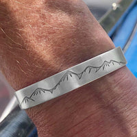 Snowcap Mountains Cuff Bracelet- Great gift for men and women worn on a wrist showing a mountain range design.