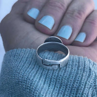 Snowflake Adjustable Ring displayed on a hand with pastel blue nails, showcasing its detailed design and adjustable band.