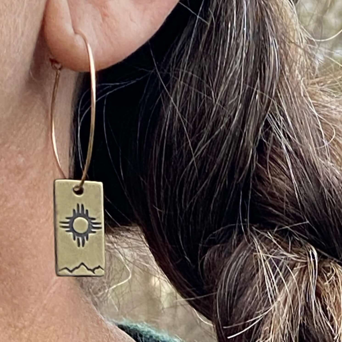 Sol Hoop Earrings featuring etched Zia sun design in raw brass, showcasing a stylish look and 1.0" diameter hoop.