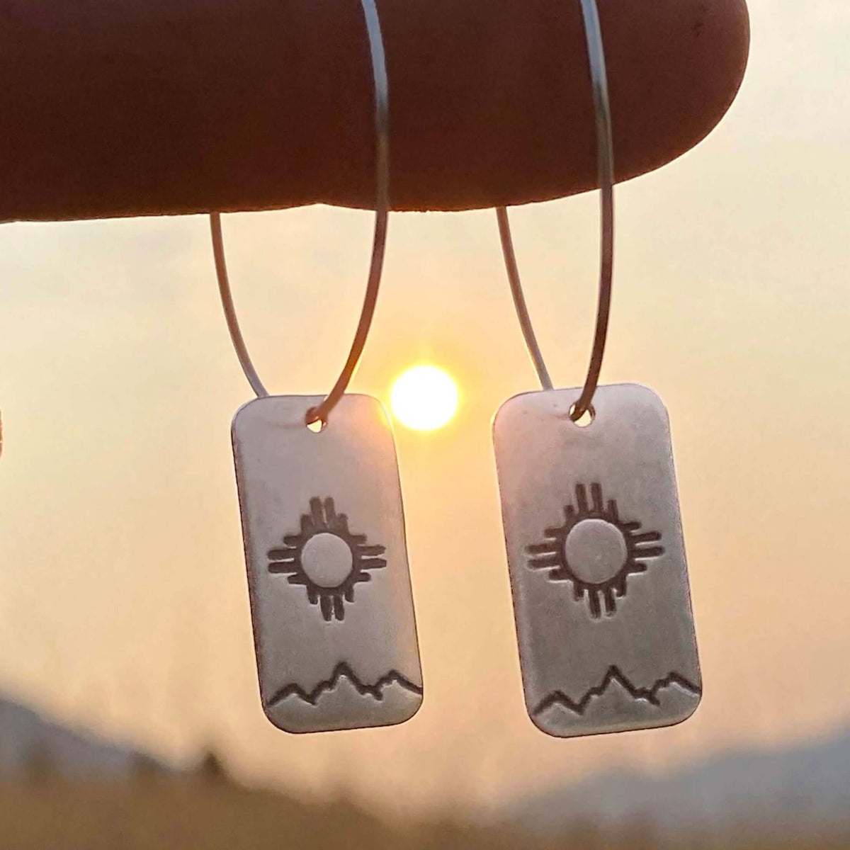 Sol Hoop Earrings featuring the Zia sun design, crafted in raw brass with sterling silver or 14k gold filled earwires.