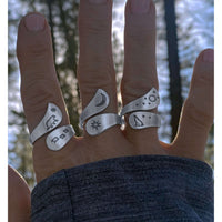 Solar Adjustable Ring showcasing sun, crescent moon, and nature designs on multiple fingers.