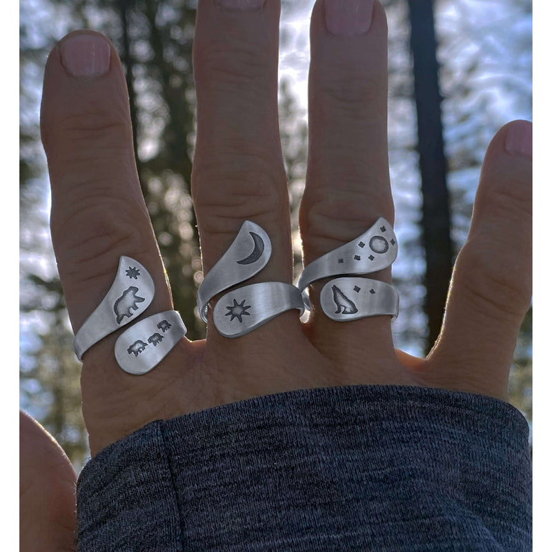 Solar Adjustable Ring showcasing sun, crescent moon, and nature designs on multiple fingers.
