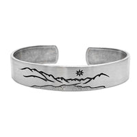 St. Mary Cuff Bracelet featuring a mountain and star design on a silver cuff, 1/2 inch wide and adjustable.