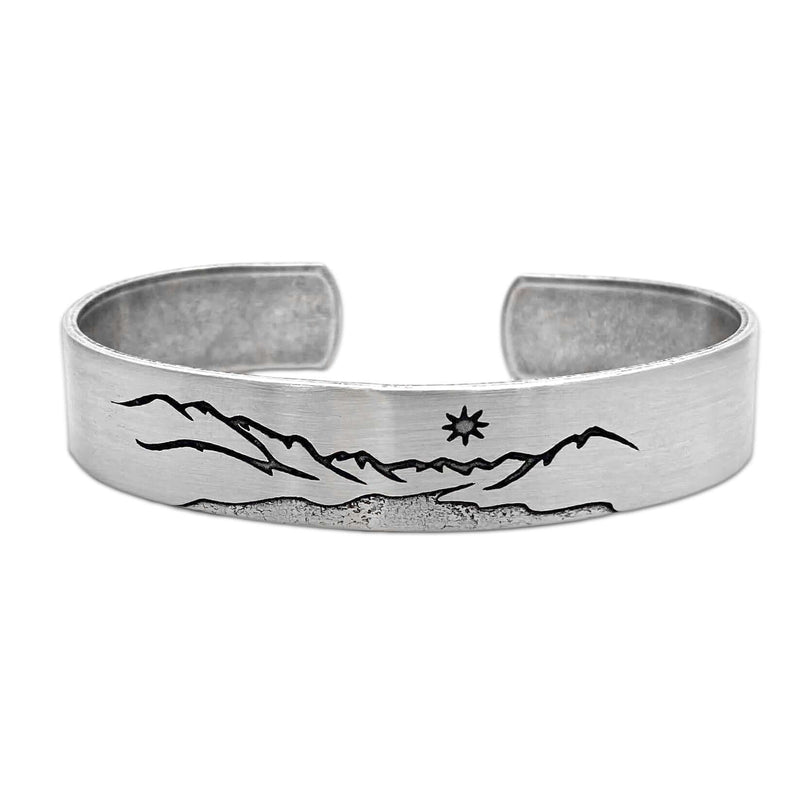 St. Mary Cuff Bracelet featuring a mountain and star design on a silver cuff, 1/2 inch wide and adjustable.