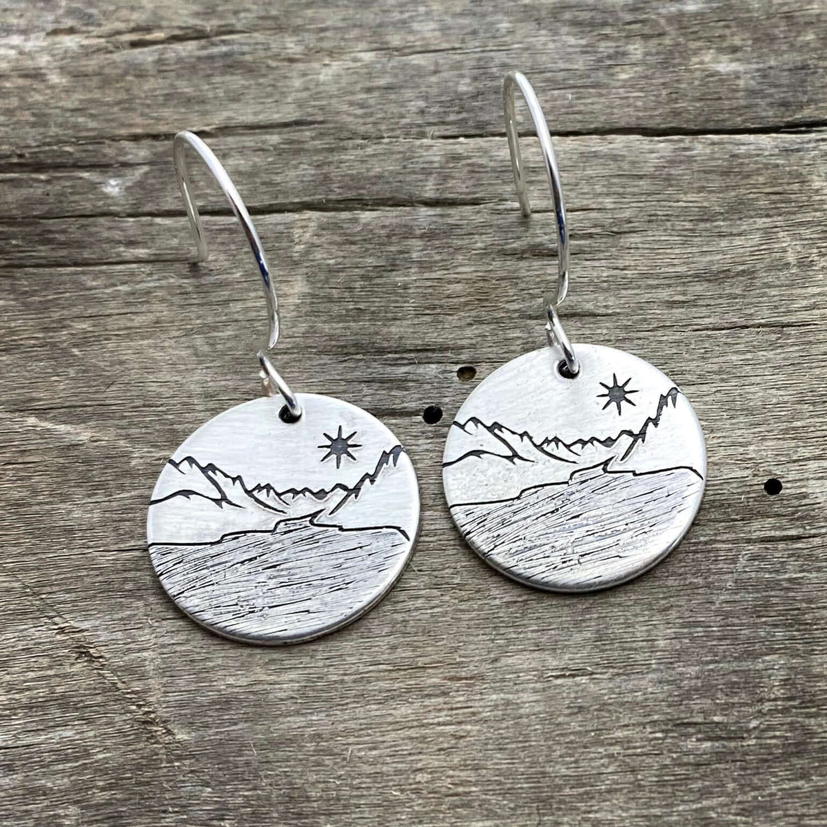 St. Mary Lake Earrings - Glacier Mountain and Lake with Sun showcasing etched brass design with mountains and sun.