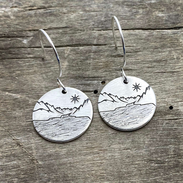 St. Mary Lake Earrings - Glacier Mountain and Lake with Sun showcasing etched brass design with mountains and sun.