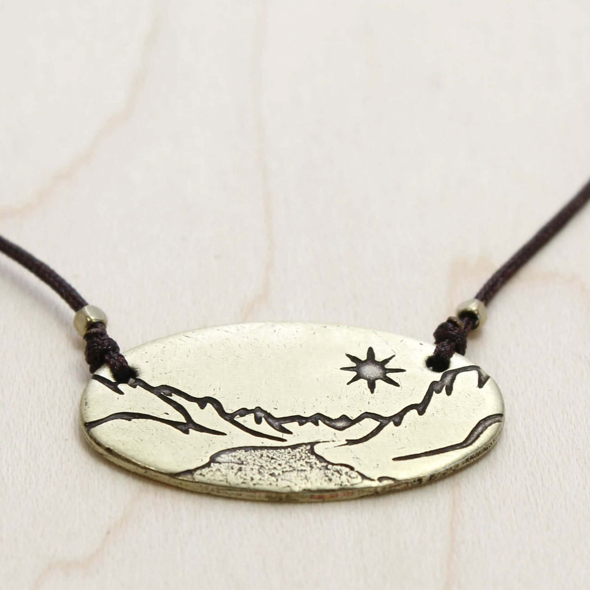 St. Mary Lake in Glacier Necklace featuring intricate acid-free etching design in Antique Brass finish.