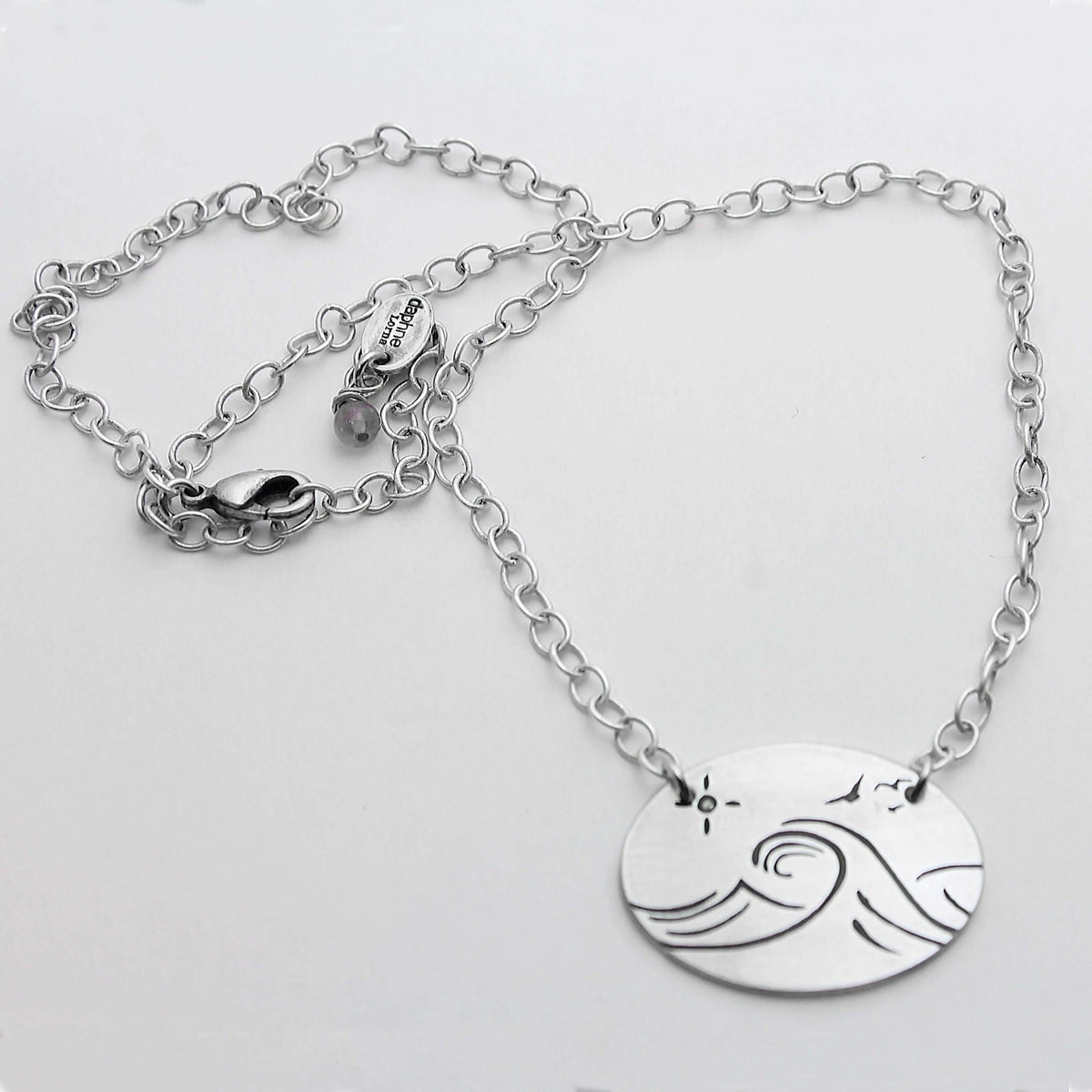 Swell Necklace featuring wave etched design in matte silver, adjustable 18" cable chain, handmade in Montana.