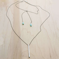 Twig Long Layered Necklace on a wooden background with adjustable chain and turquoise accents.