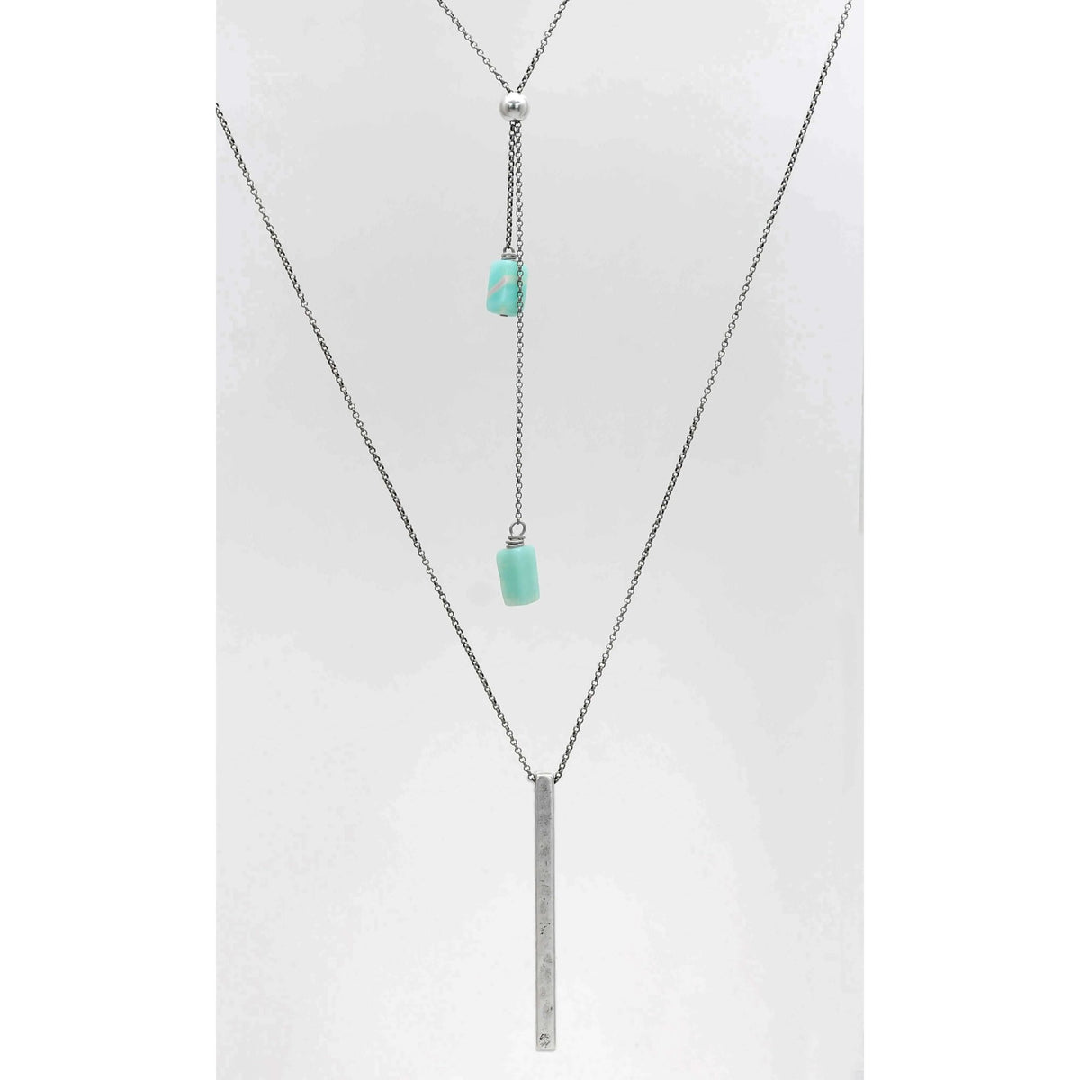 Twig Long Layered Necklace featuring a silver chain with turquoise accents and a sleek bar pendant.