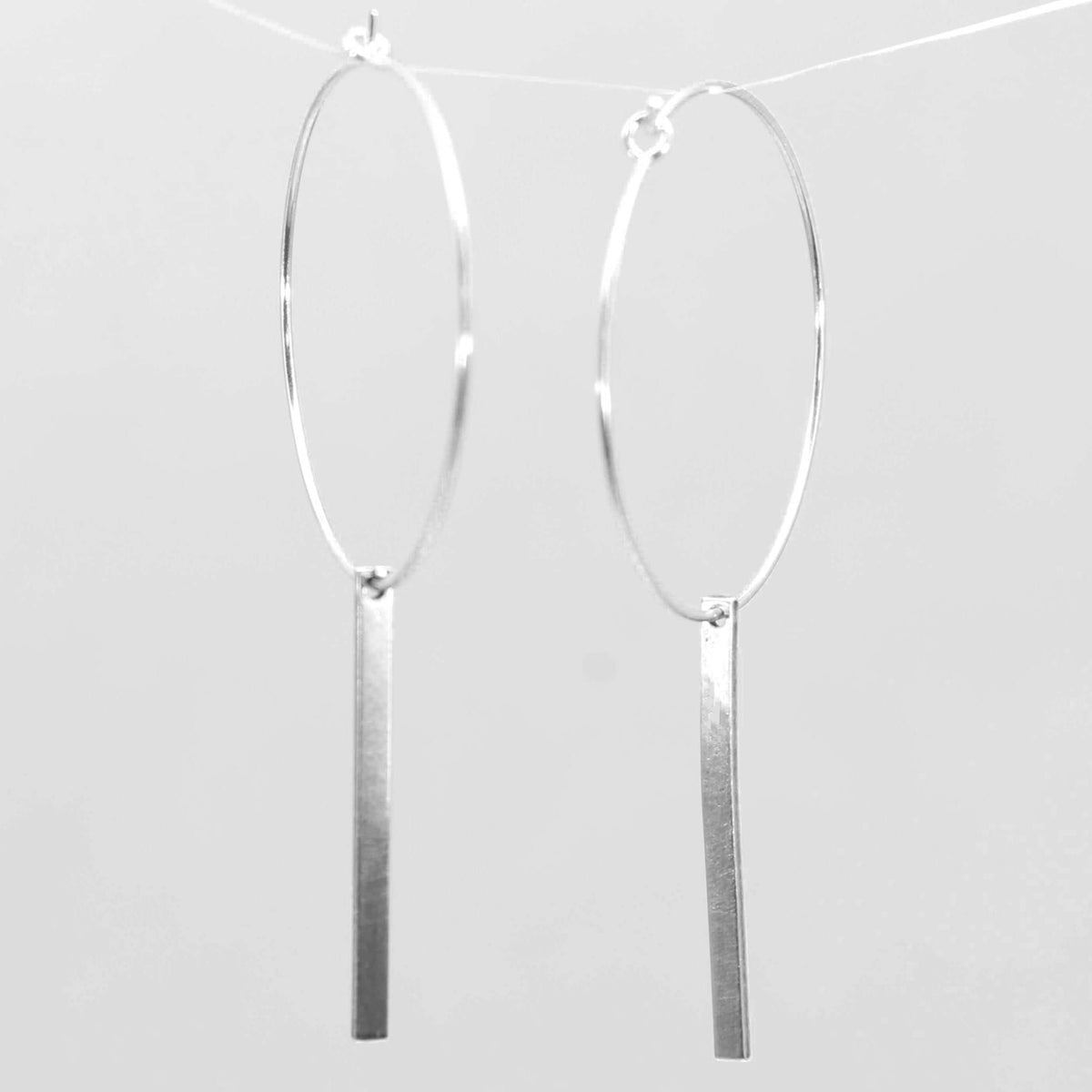 Twigs Hoop Earrings in Matte Silver featuring sleek twig design and classic hoop style.