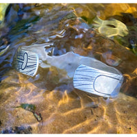 Upstream Cuff Bracelet - Paddle River Rafting Adventure resting in clear water with intricate paddle etching.