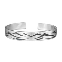 Waves Cuff Bracelet featuring intricate wave patterns in matte silver finish, adjustable fit for any wrist size.