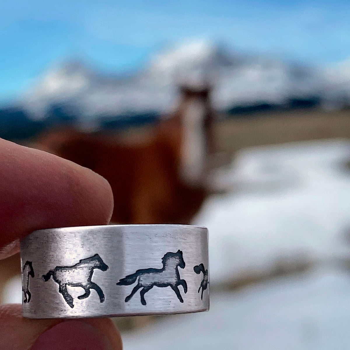 Wild Horses Adjustable Ring featuring galloping horses, set against a serene mountain backdrop.