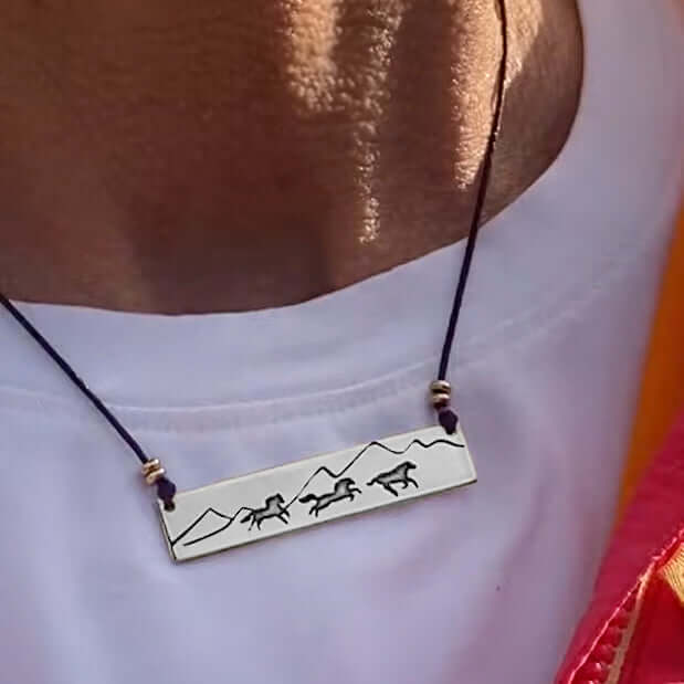 Wild Horses Necklace featuring etched mountains and horses, showcasing freedom and wild west spirit.