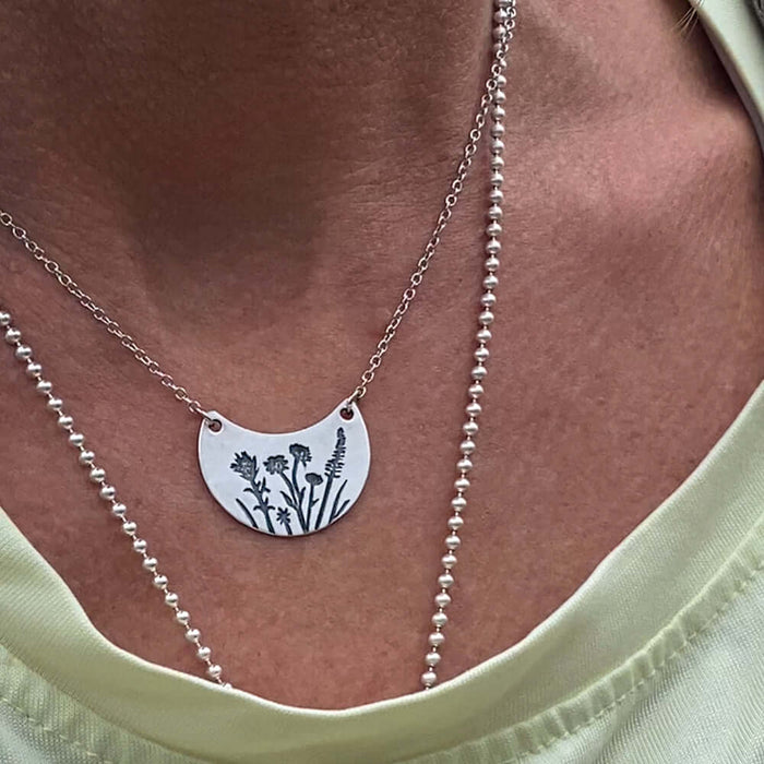 Wildflower Basket Necklace featuring delicate wildflower engravings, perfect for spring and summer outings.