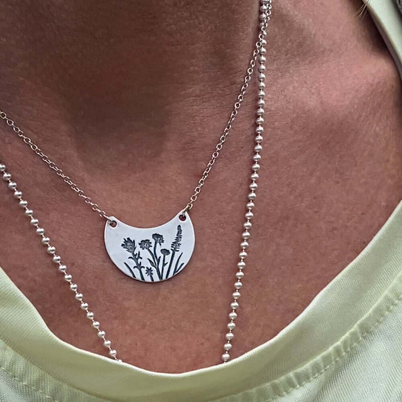 Wildflower Basket Necklace featuring delicate wildflower engravings, perfect for spring and summer outings.