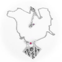 Wildflower Box Necklace featuring Indian Paintbrush and Wild Lupine on a matte silver finish with pink stones.