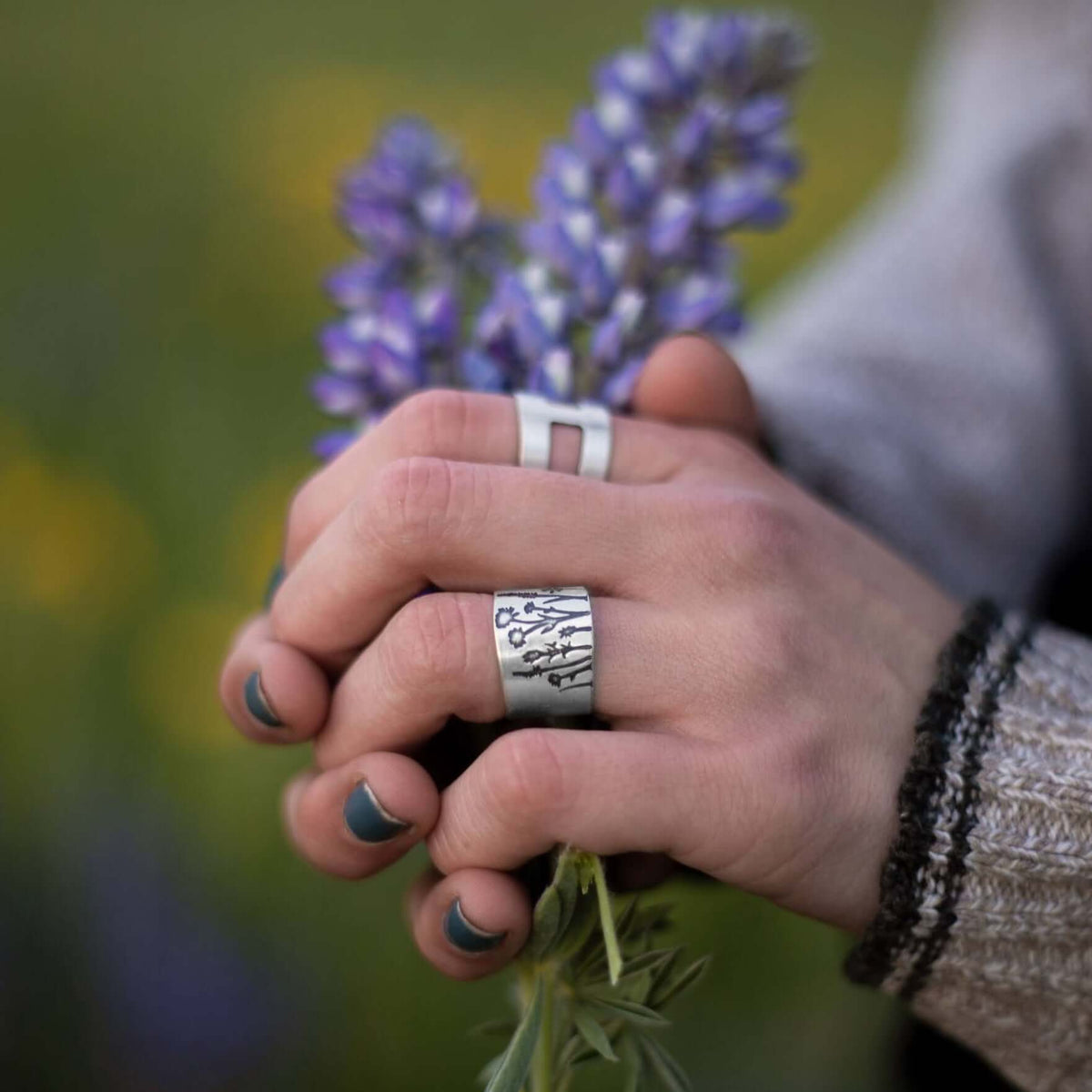 Wildflowers Adjustable Ring worn with purple wildflowers in hand, showcasing spring beauty and floral inspiration.